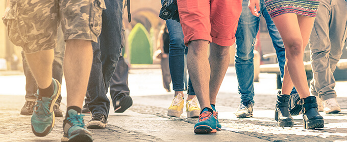 In a crowded street, people are walking by.